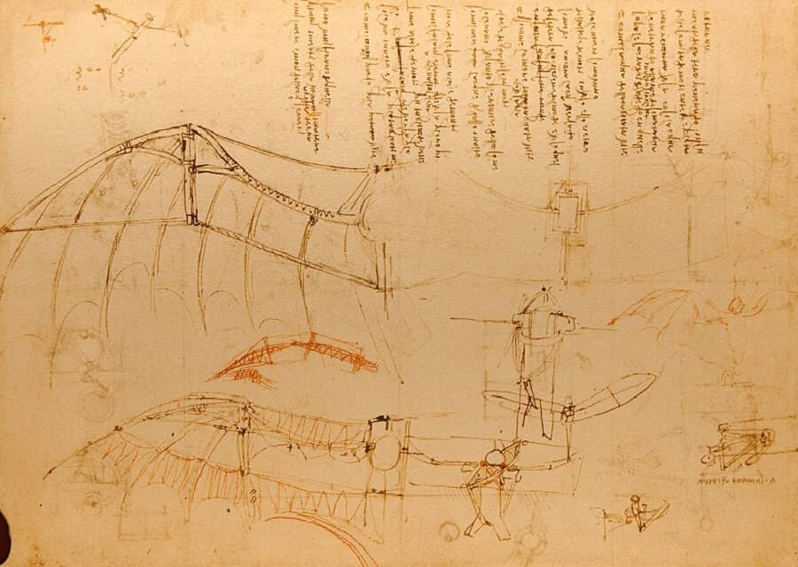 Leonardo da Vinci’s sketch of an early flying machine, showing wing-like structures inspired by birds and bats, along with handwritten notes in Italian, reflecting his pioneering exploration of human flight.